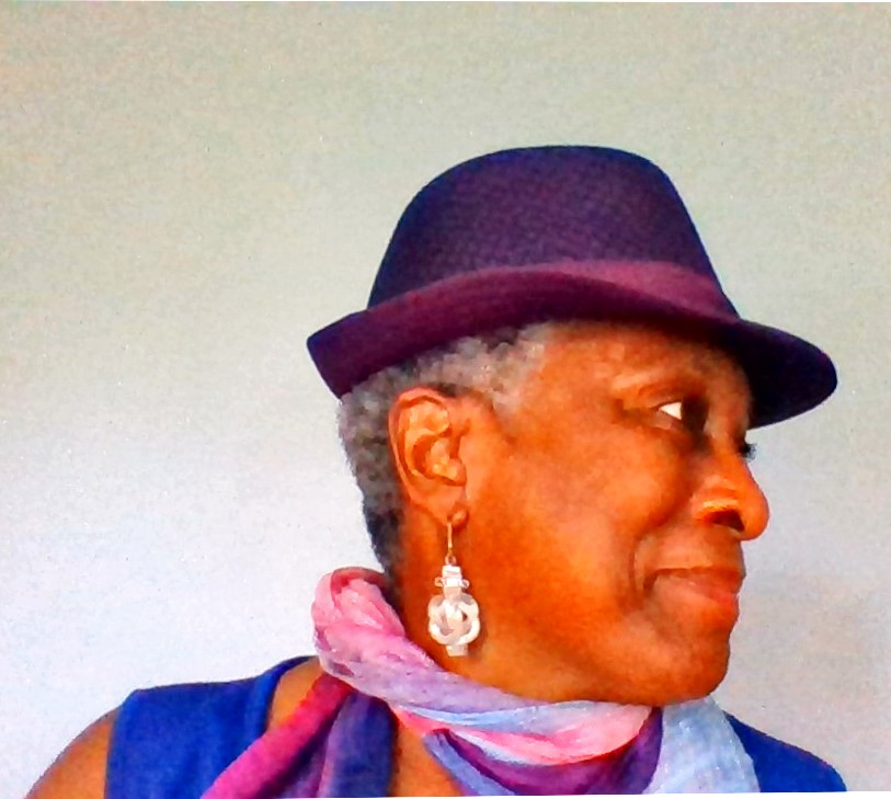 Headshot of Elizabeth Ann Terry. Elizabeth Ann is a Black woman wearing a scarf, dangly earrings, and a hat.