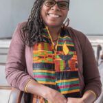 picture of a Black Unitarian Universalist minister, Kimberly Quinn Johnson, wearing a colorful stole.