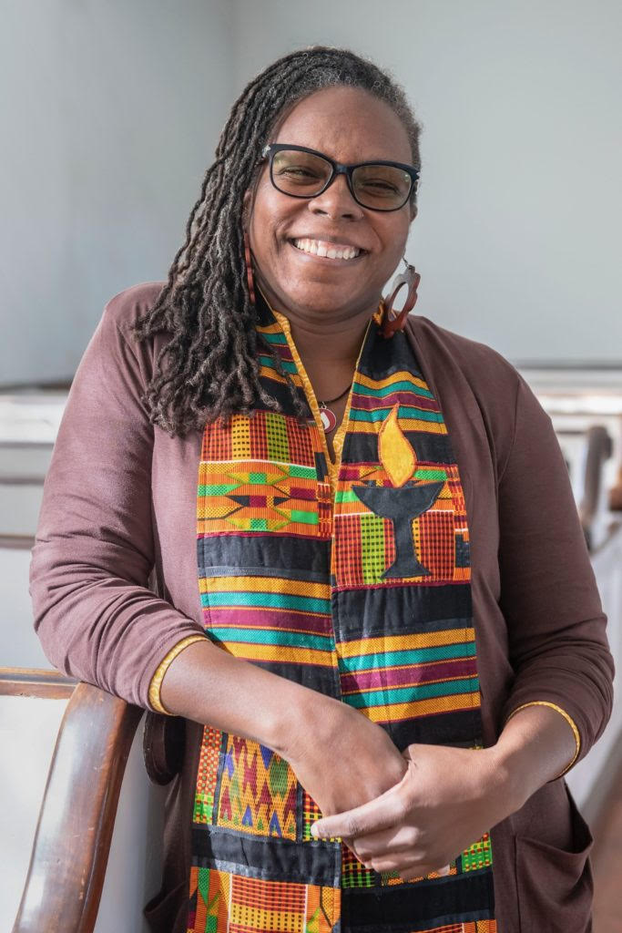 picture of a Black Unitarian Universalist minister, Kimberly Quinn Johnson, wearing a colorful stole.