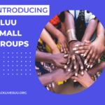 Group of Black people stacking hands.